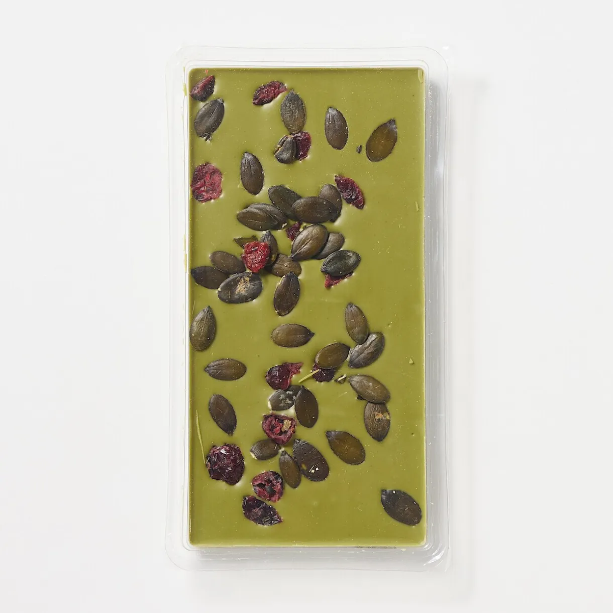 Chocolat blanc avec des canneberges sucrées, des graines de citrouille et du thé vert matcha
